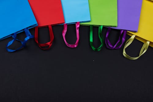 Colorful Paper Bags Over a Black Surface