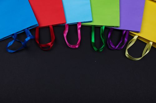Free A vibrant arrangement of colorful shopping bags displayed on a black background. Stock Photo