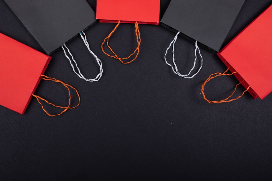 Flat-lay of red and black paper bags with cord handles