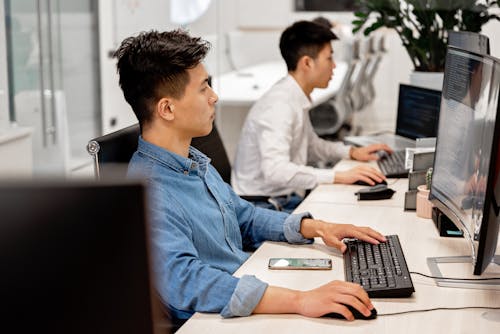 Men Sitting in Front of the Computer while Working