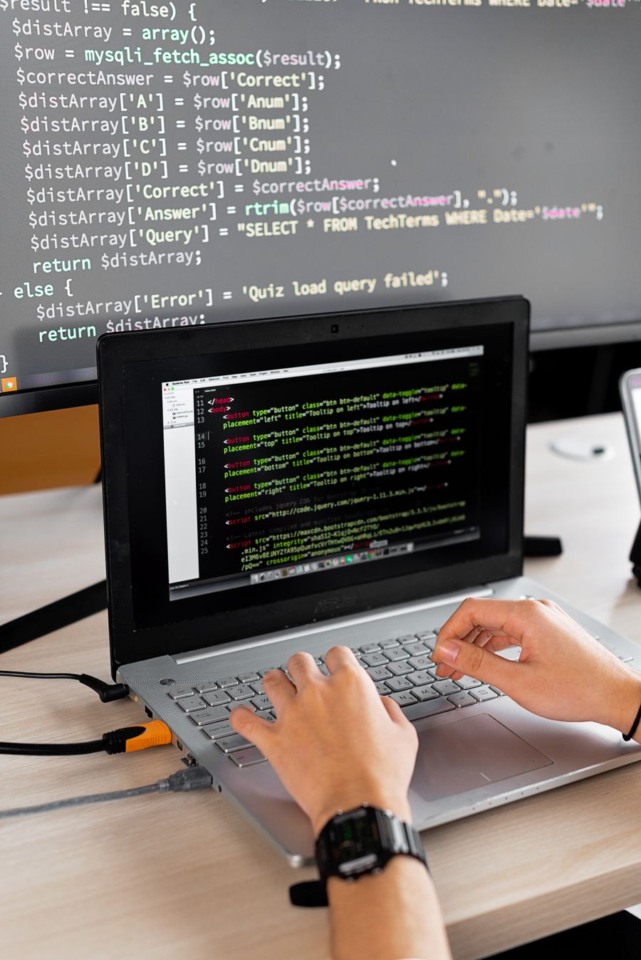 Engineer building automated workflows on dual screens