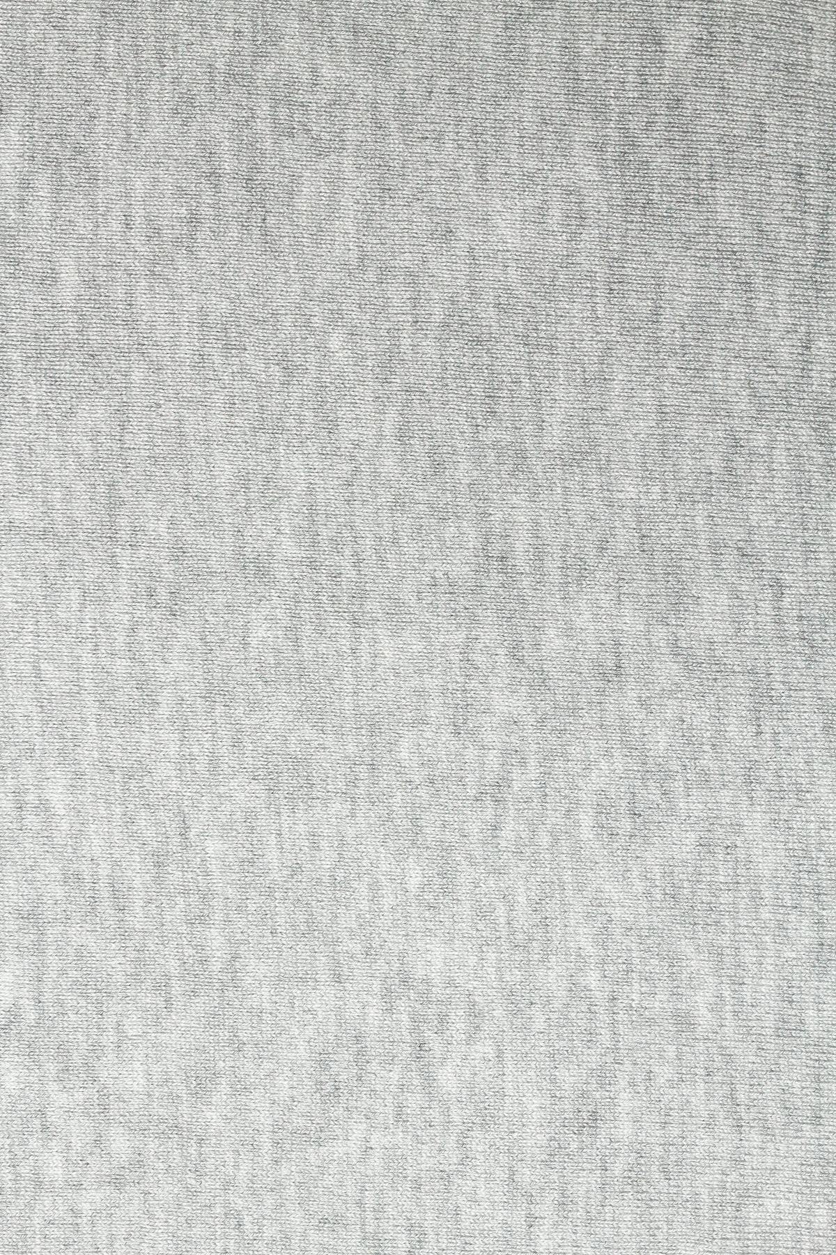 Audio engineer at a mixing console with multiple screens