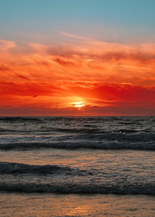 Ocean Waves Crashing on Shore during Sunset