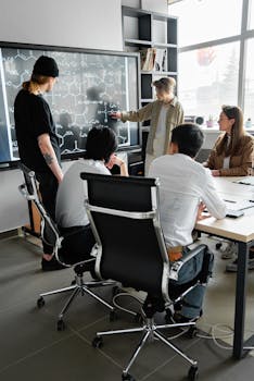 Group of professionals engaged in a collaborative meeting in a modern conference room.
