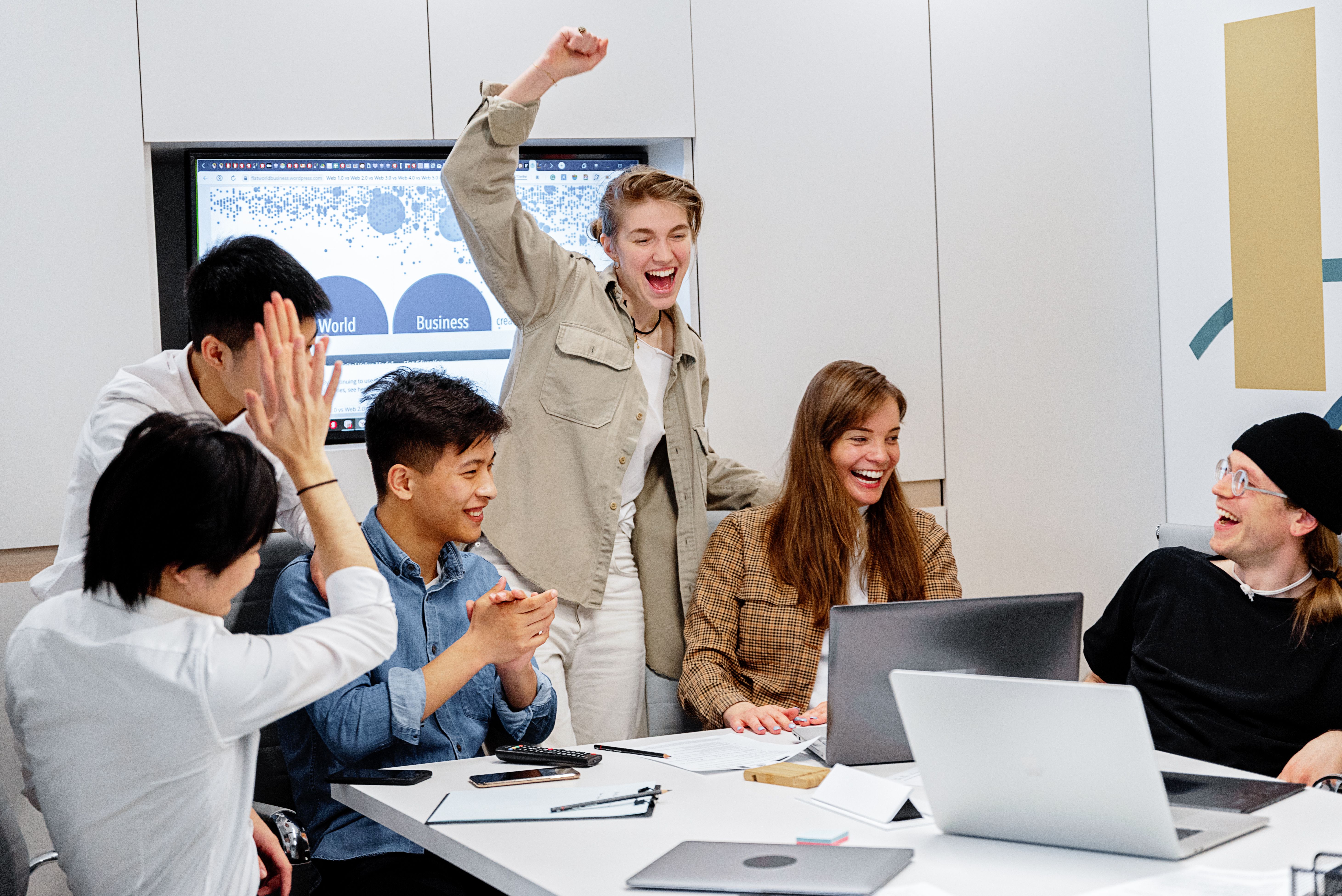 A business team celebrating progress together in an office