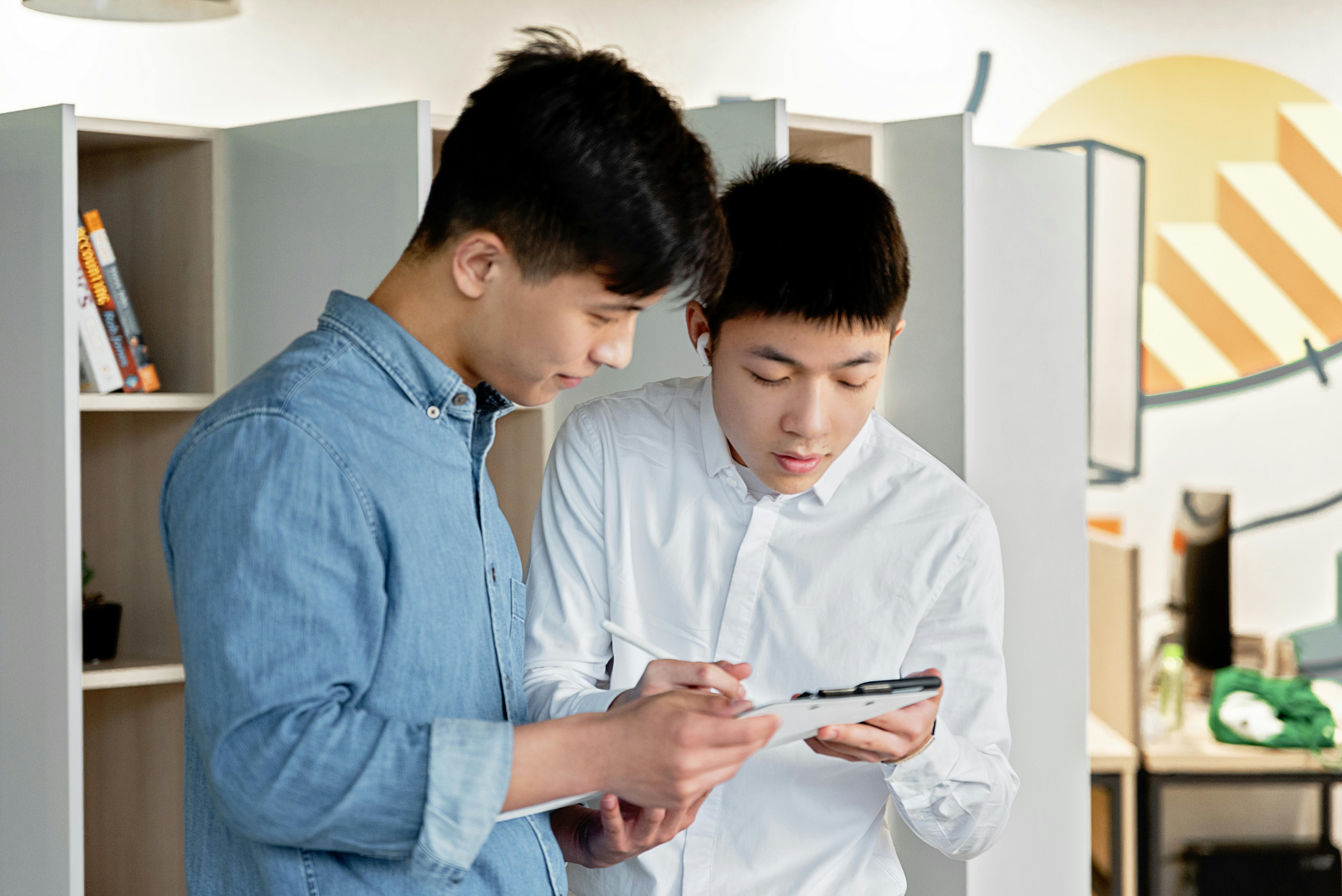 man in blue dress shirt holding smartphone