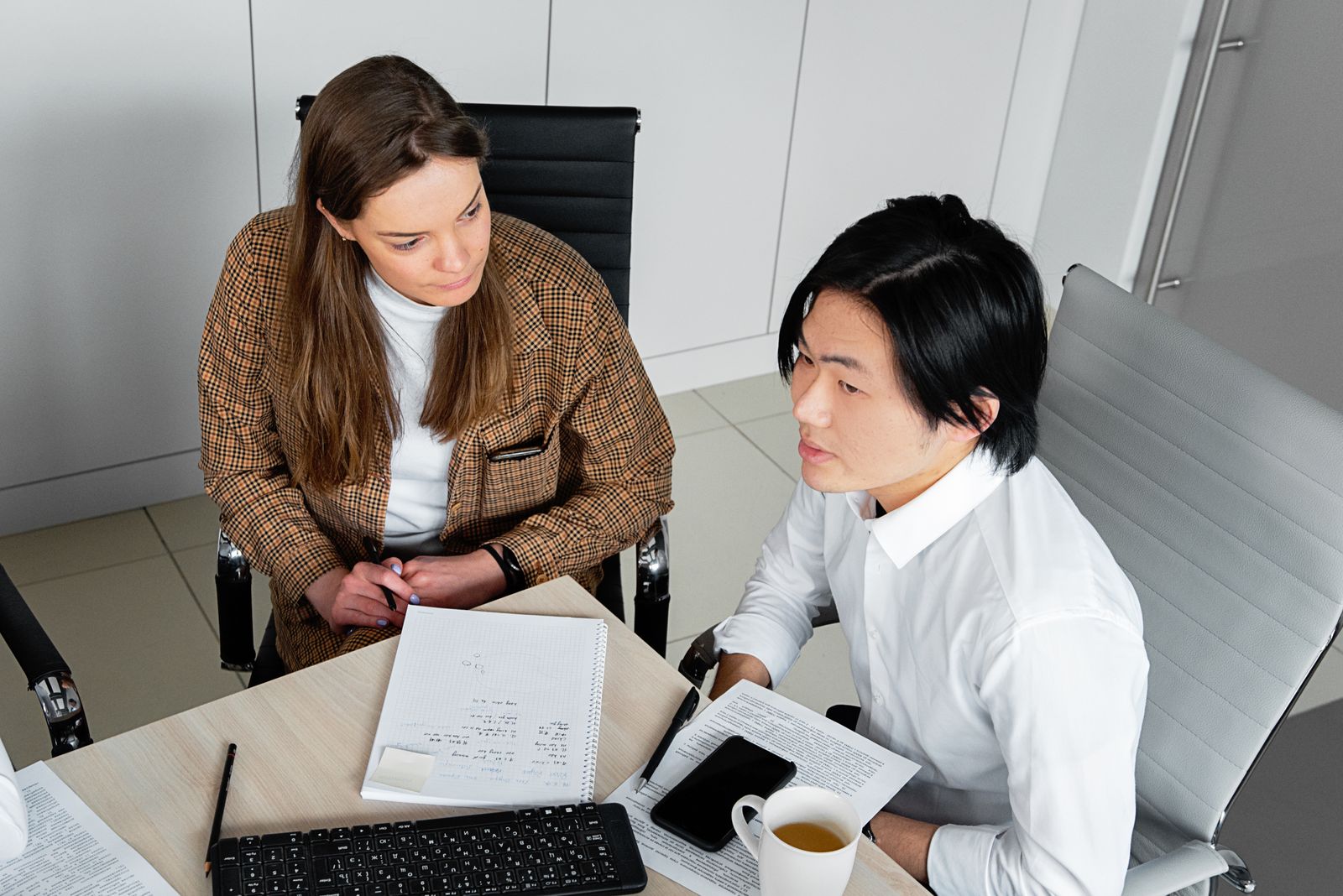 Colleagues reviewing documents together in an office