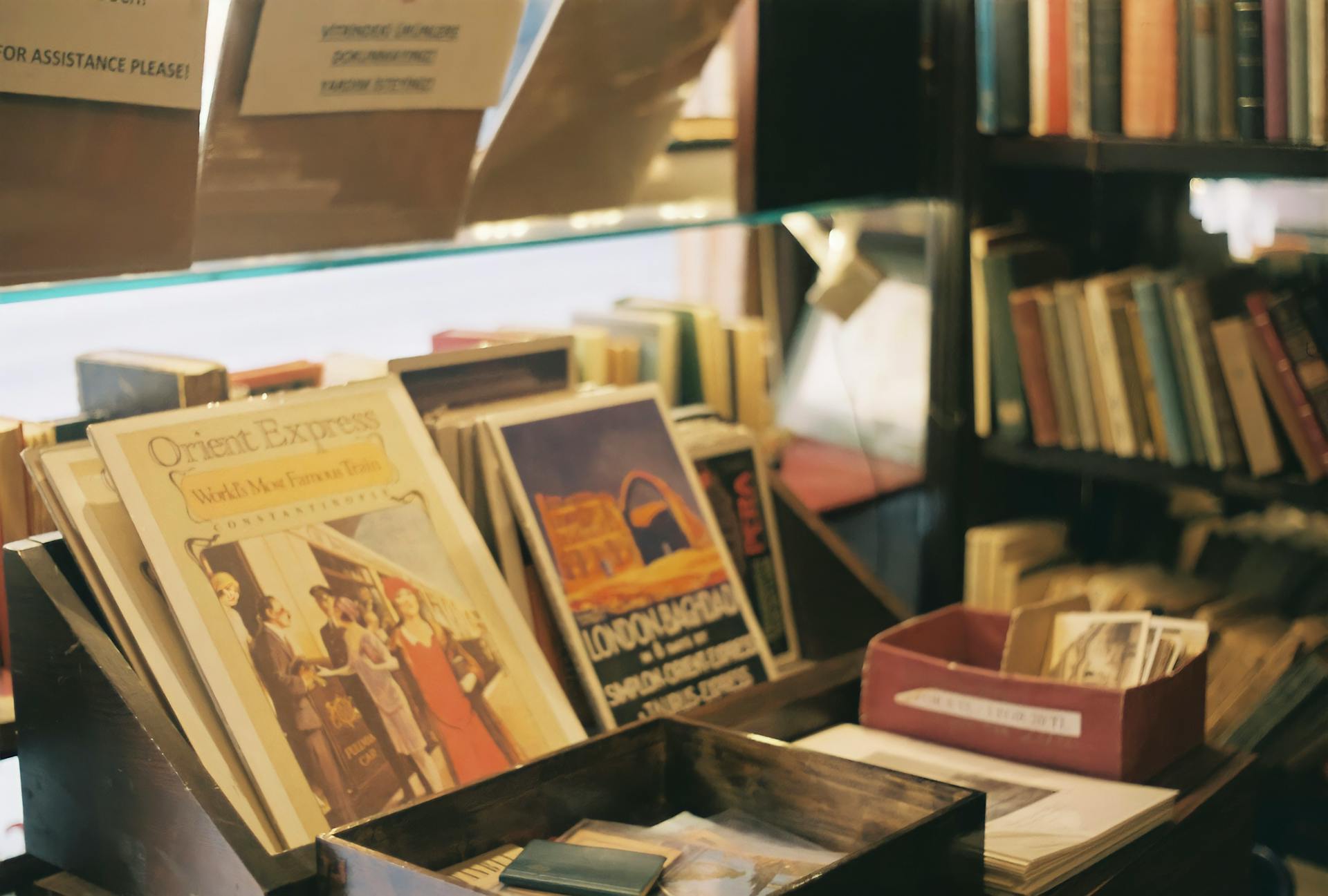 Cozy bookstore interior showcasing vintage posters and a collection of books on wooden shelves.