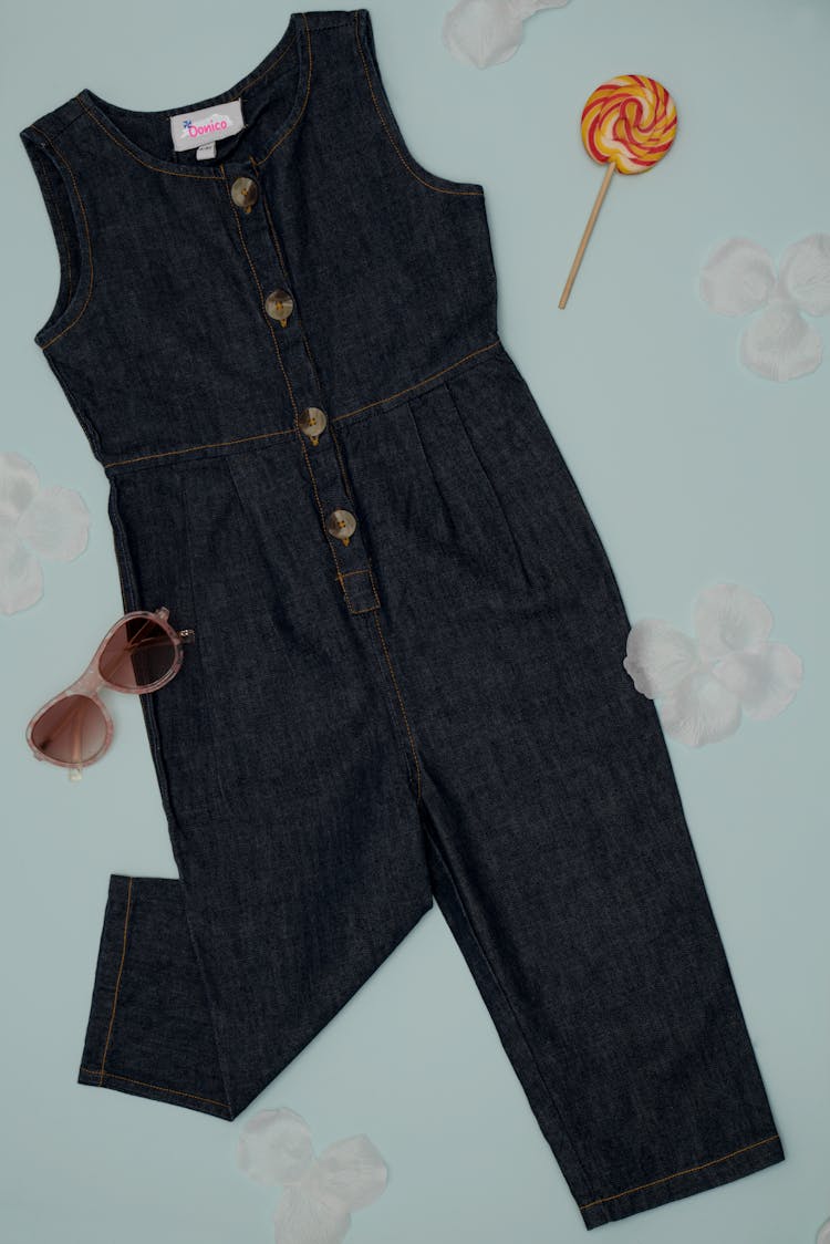 A Girls Denim Jumpsuit And Sunglasses