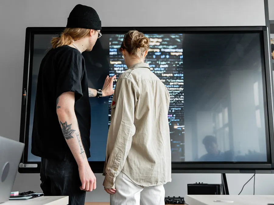 Colleagues collaborating on a large screen