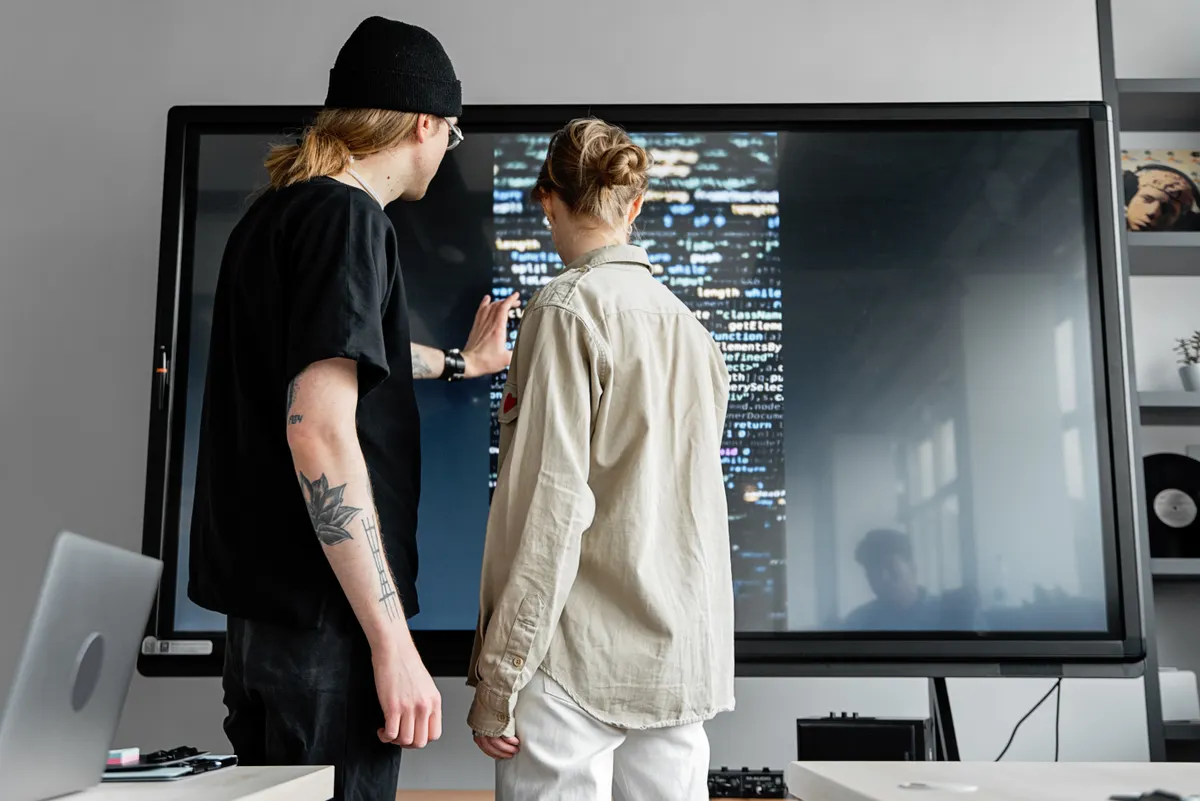 Team using editorial oversight to review AI content on a large screen.