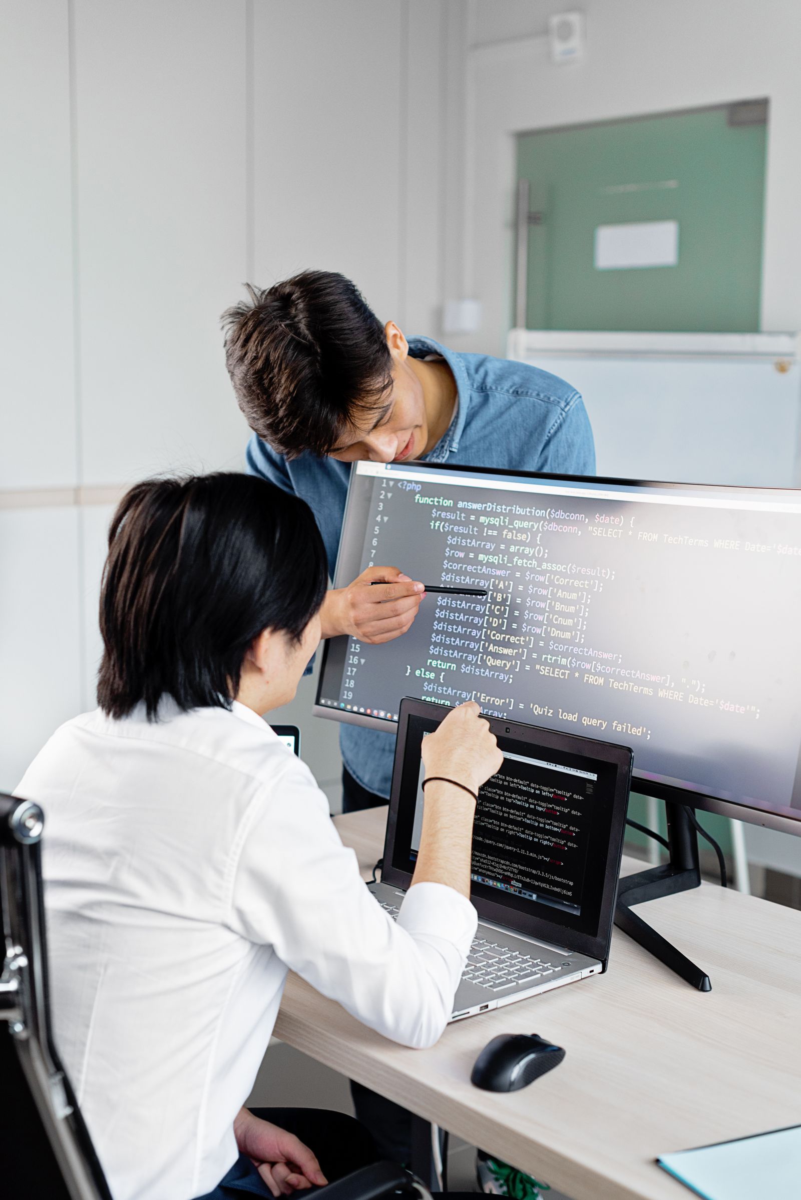 Software professionals reviewing code together in a modern development workspace