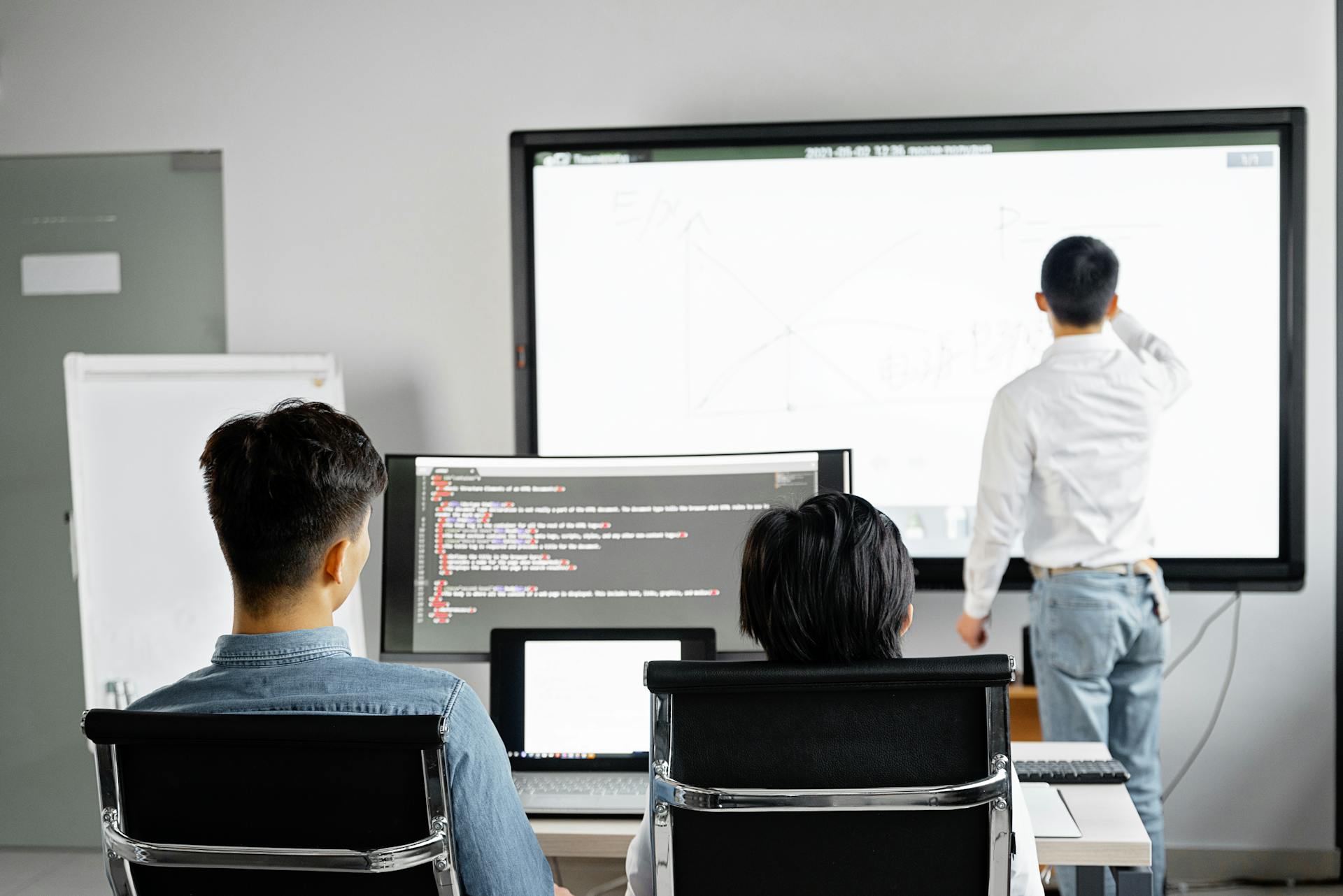 Team conducting a business presentation with technology in a modern office setting.