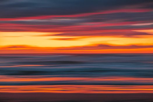 Stunning long exposure of a vibrant sunset over the ocean in Kenitra, Morocco.