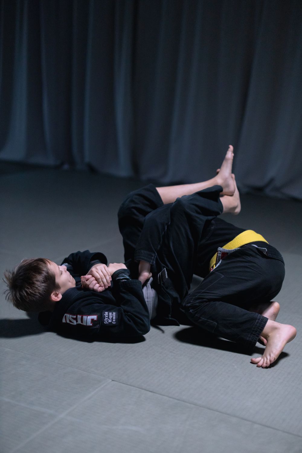 Two students in gis sparring on the mat