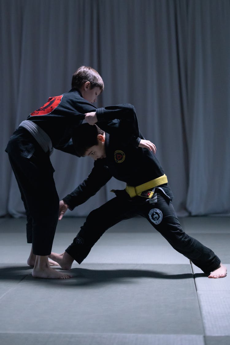 Boys Sparring On Black Mat