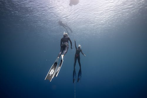 Free People diving in blue ocean Stock Photo