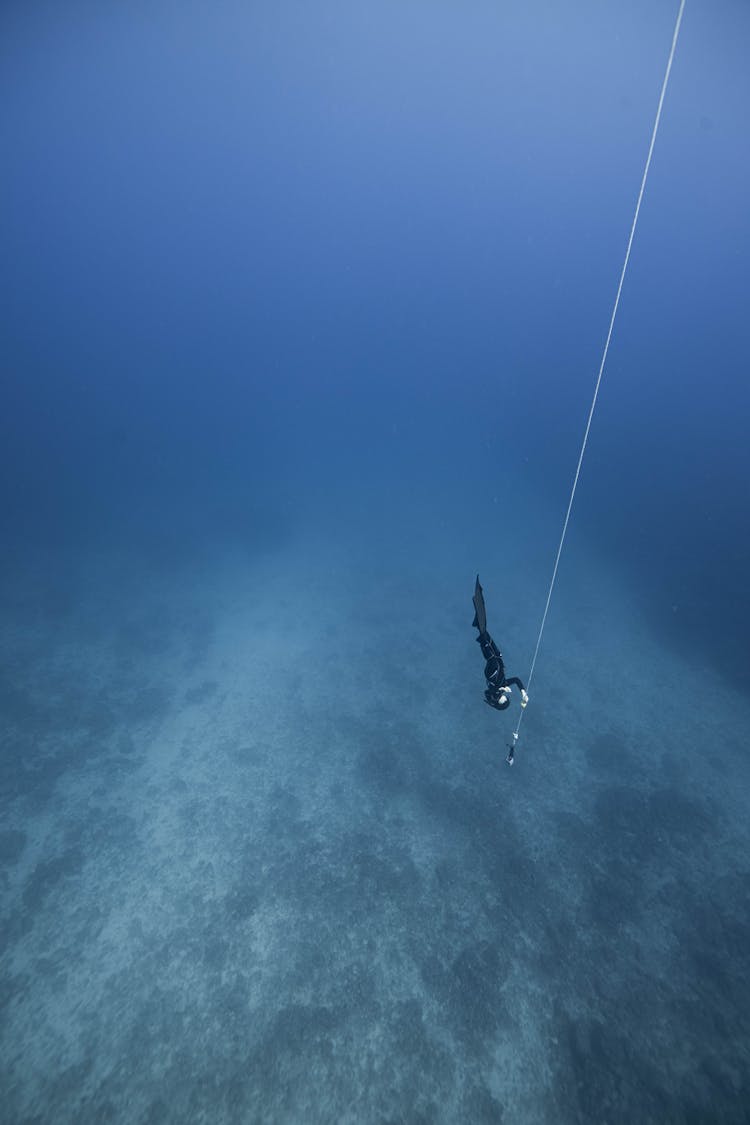 Diver With Rope In Ocean Abyss