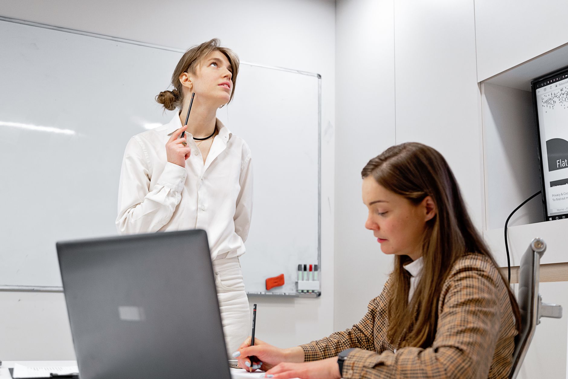 engineer pair programming at a whiteboard