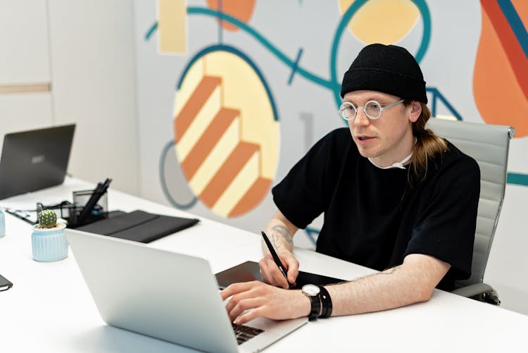 Man Using Electronics At Office Work