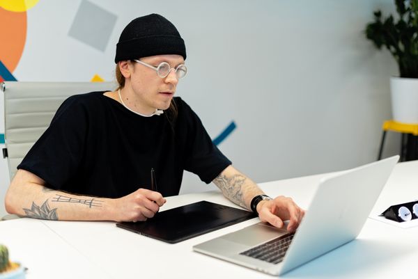 Designer working at a laptop, photo by Mikhail Nilov on Pexels