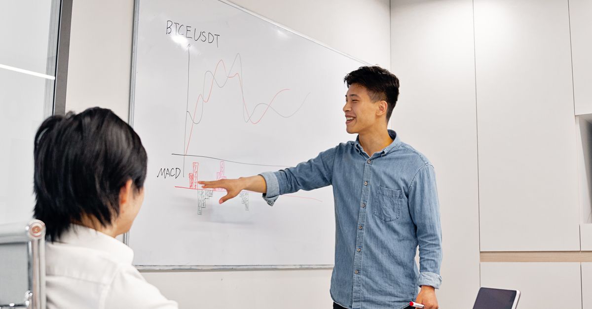 A Man Explaining a Graph on a Whiteboard · Free Stock Photo
