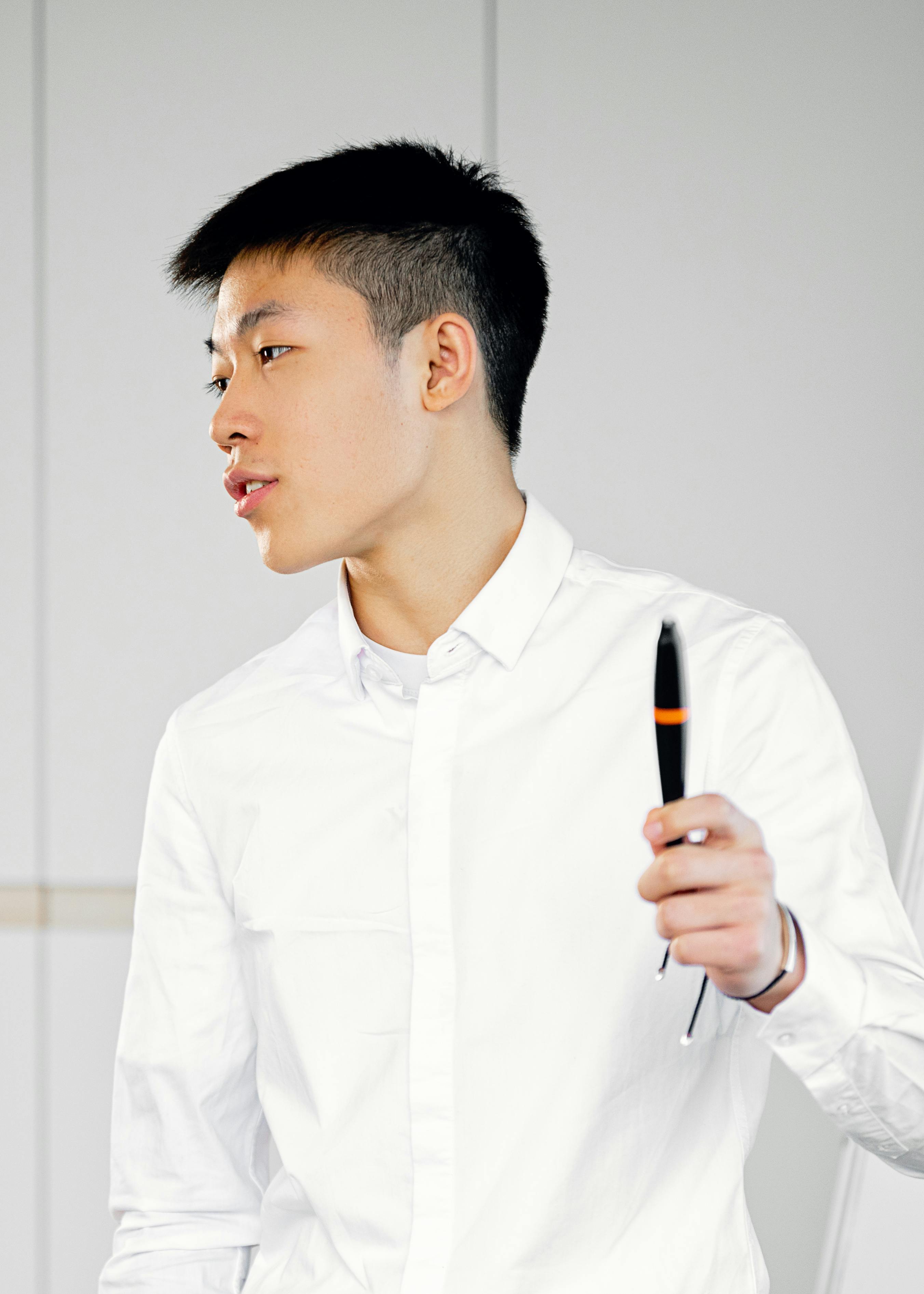 Confident young adult presenting ideas in a business setting with a stylus pen.