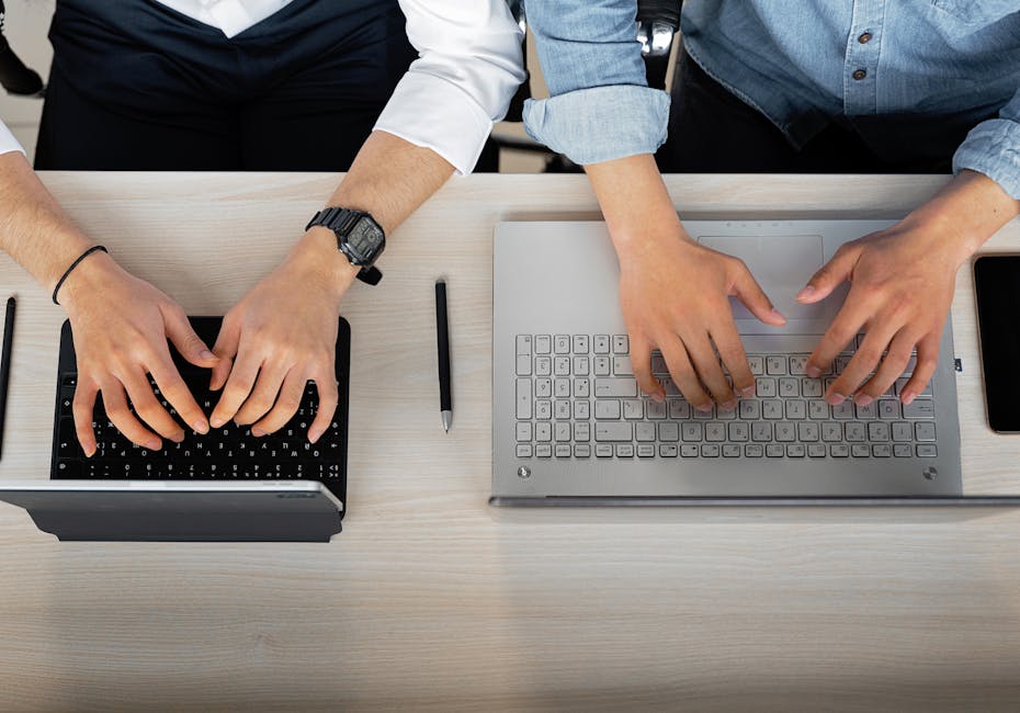 school staff setting up mobile app on laptop - School mobile applications