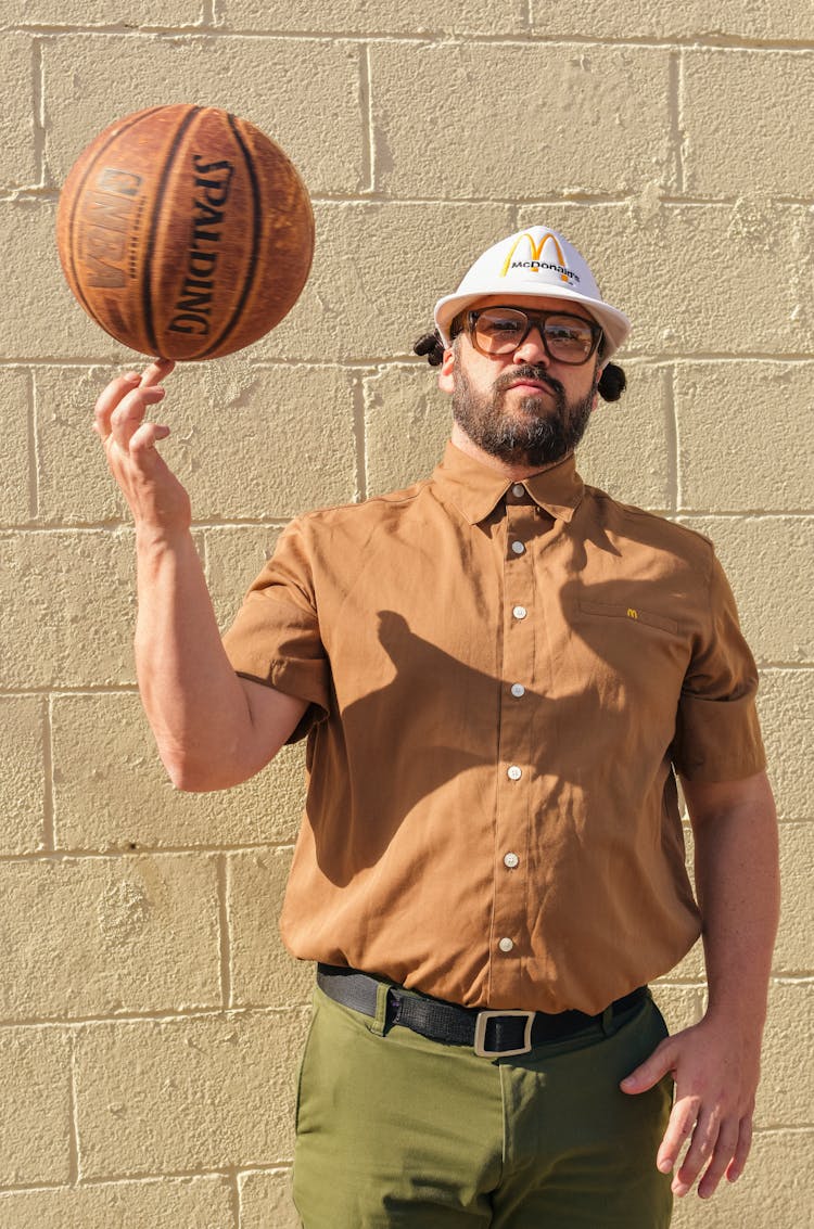 A Man Spinning A Basketball