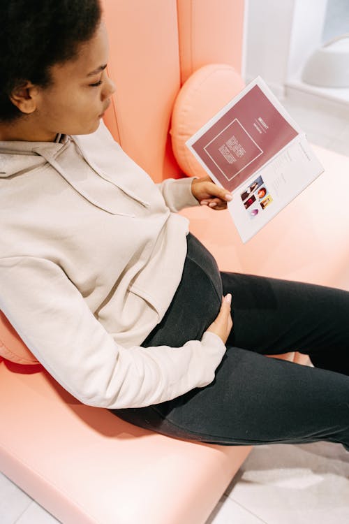 Pregnant Woman reading a Brochure