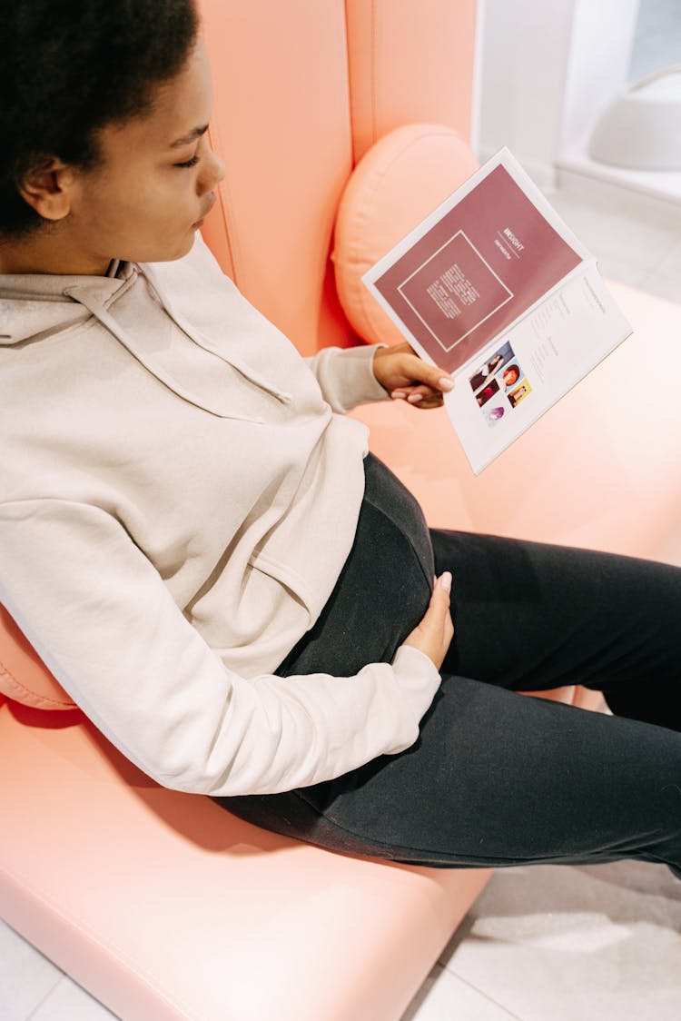 Pregnant Woman Reading A Brochure