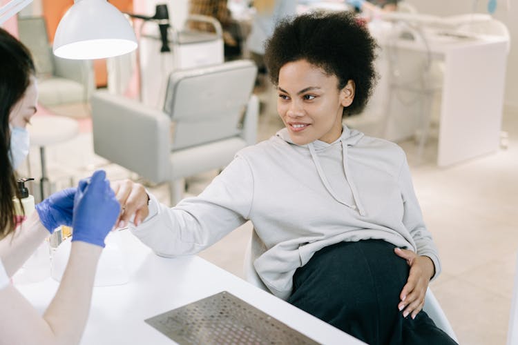 Pregnant Woman Sitting On Nail Salon