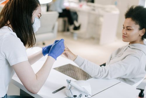 Free A woman receiving a manicure at a nail salon, focusing on self-care and relaxation. Stock Photo
