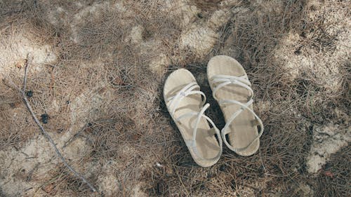Sandals on Drid Grass on Ground