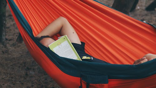 Person Lying on Red Hammock Book