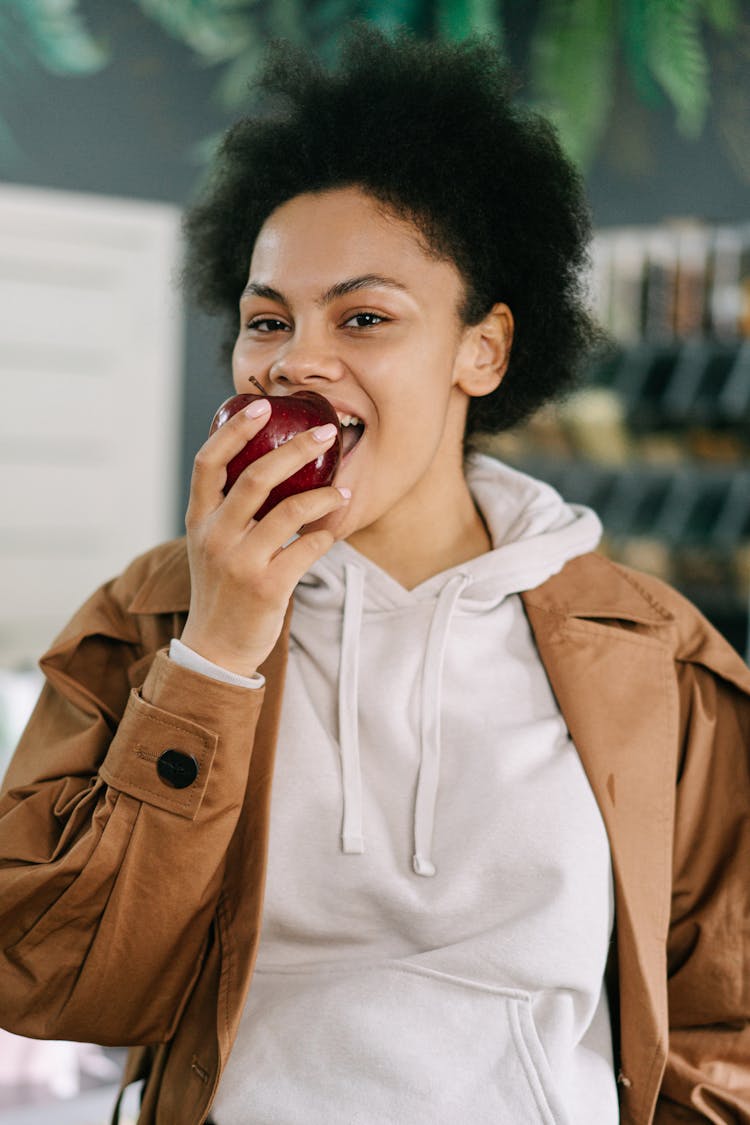 A Woman Eating An Apple 