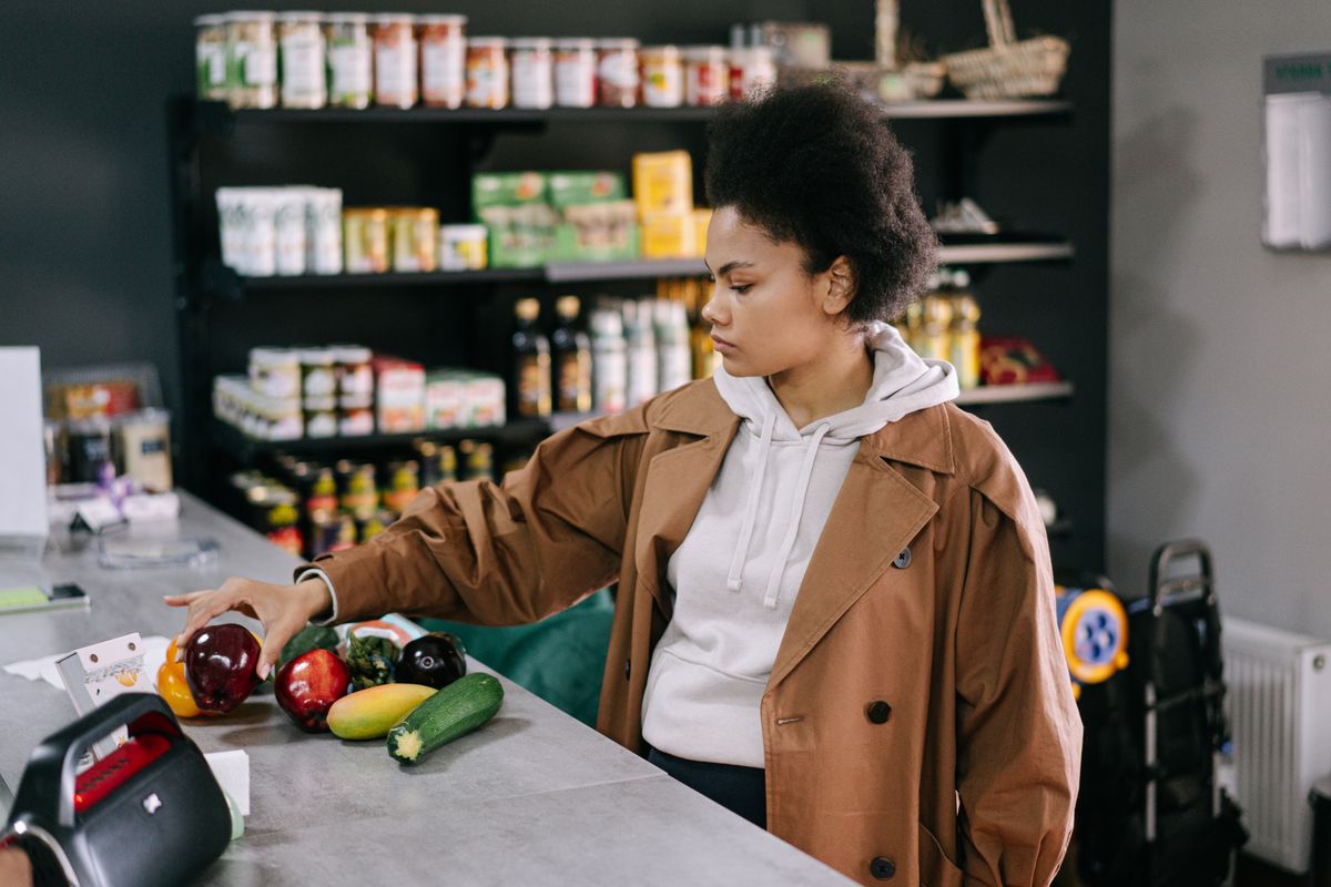 Customer choosing fresh produce in a local food shop
