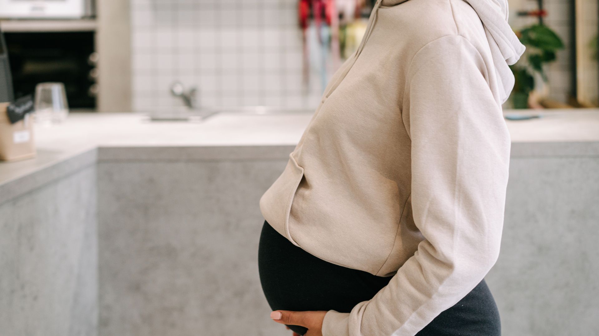 Modafinil Safety During Pregnancy: A Comprehensive Overview Pregnant woman in casual hoodie gently holding belly indoors — modafinil safety during pregnancy