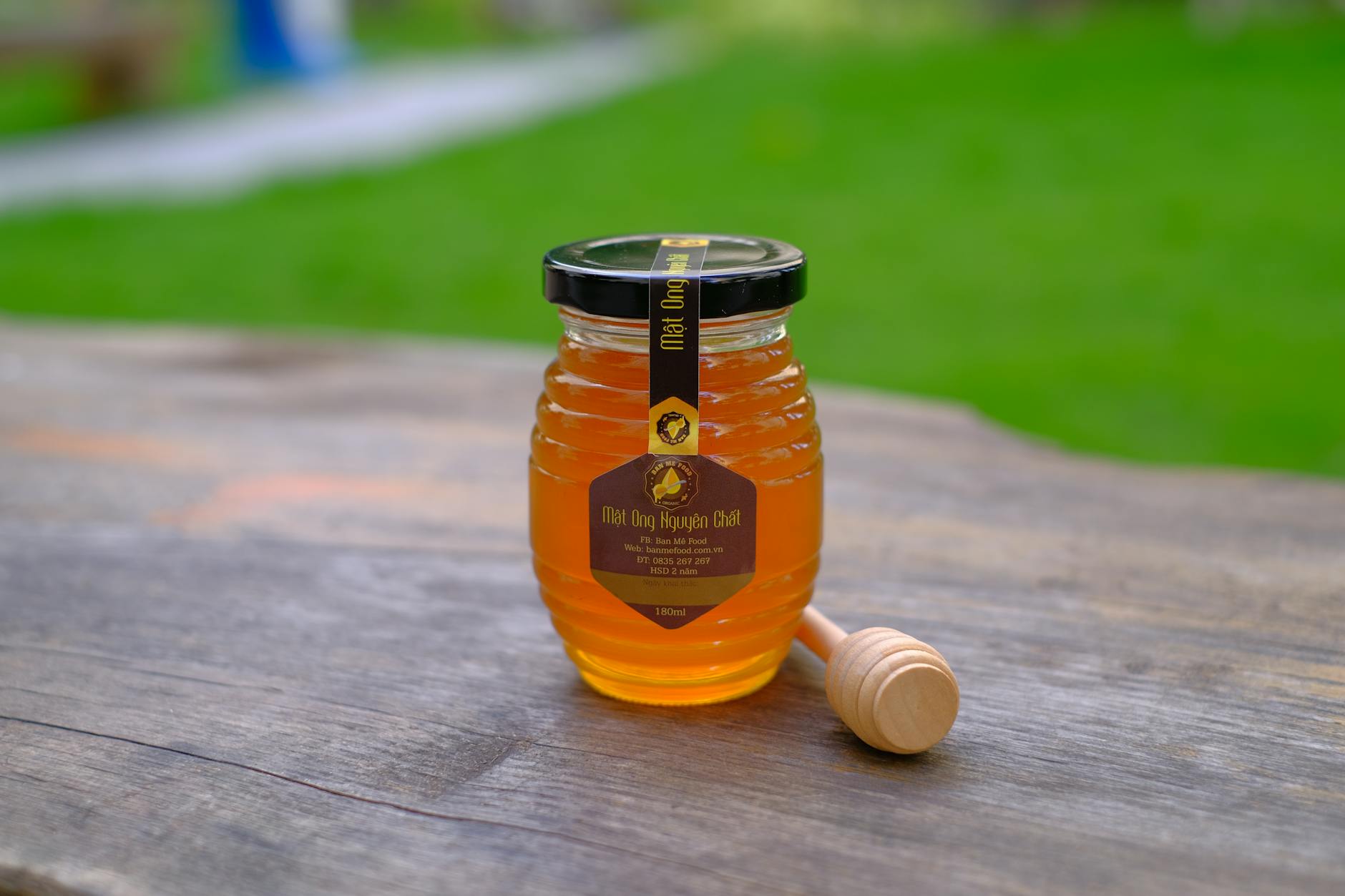 Manuka Honey In A Jar With A Honey Dipper On A Wooden Table