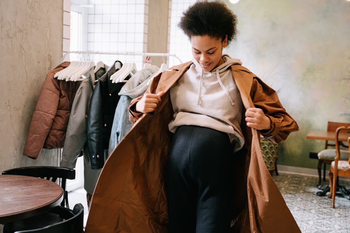 A Pregnant Woman Wearing a Brown Coat