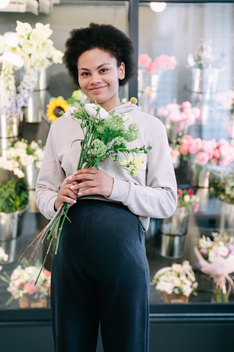 A Pregnant Woman Holding  Flowers