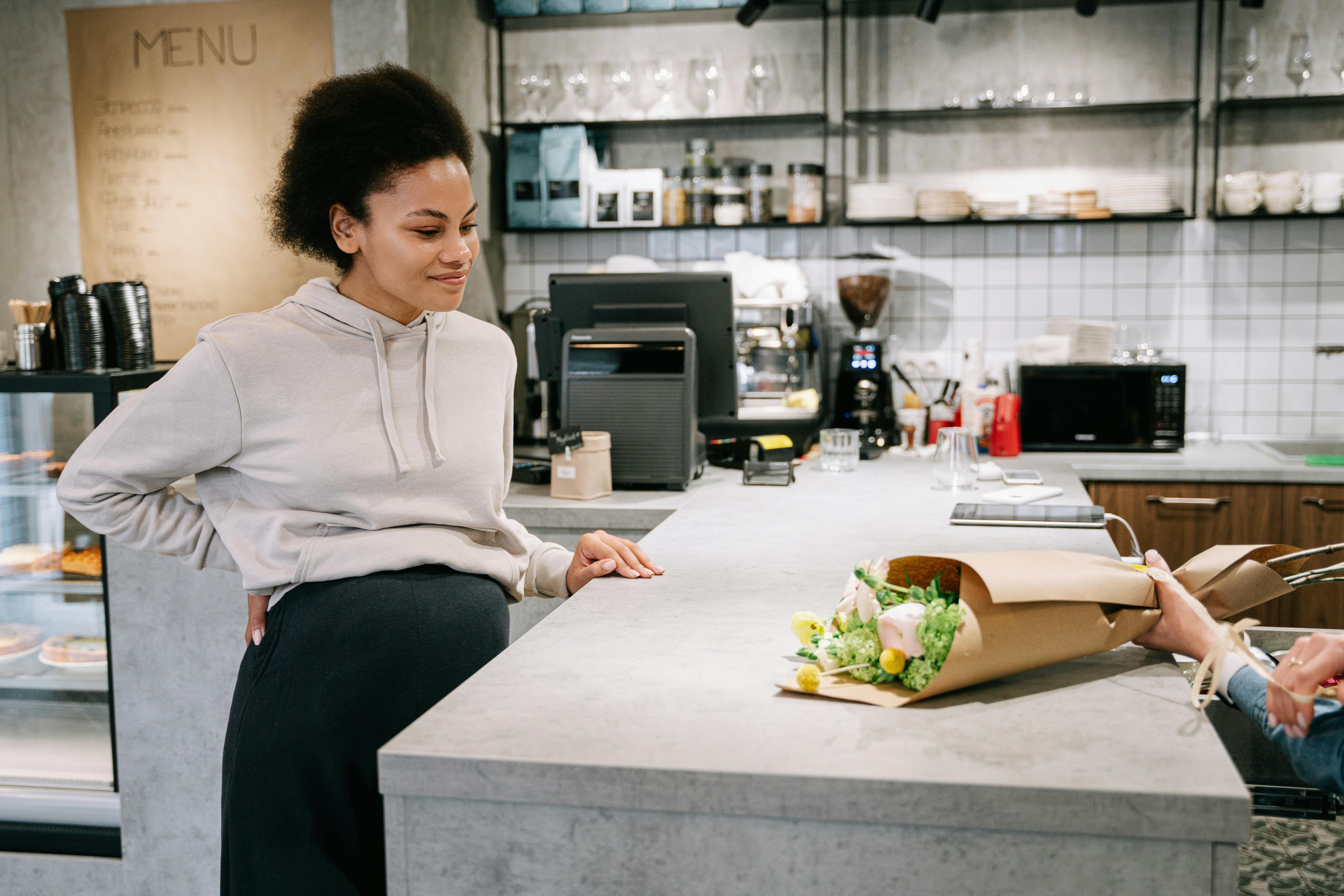 a pregnant woman standing on a counter