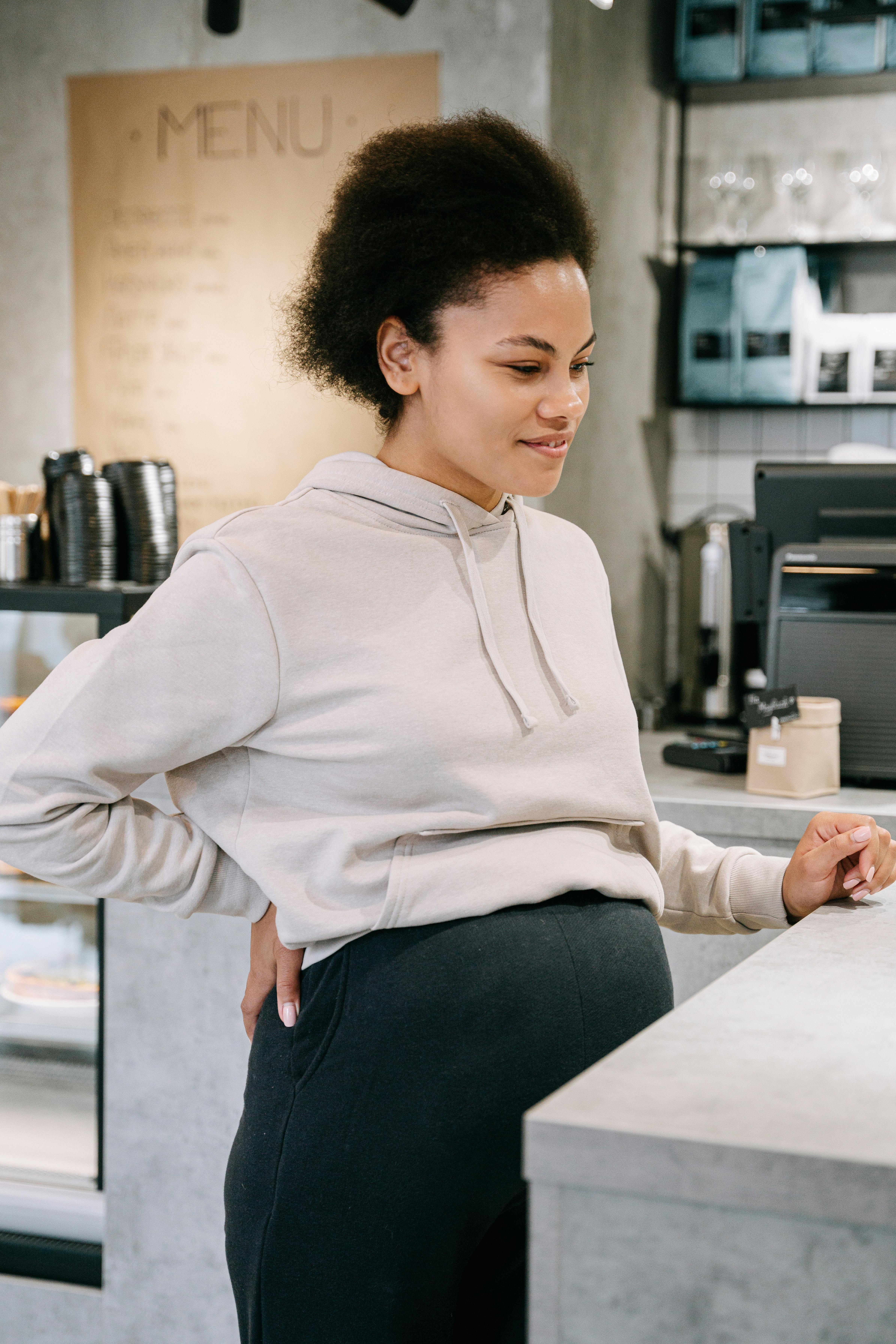 pregnant woman waiting at the counter