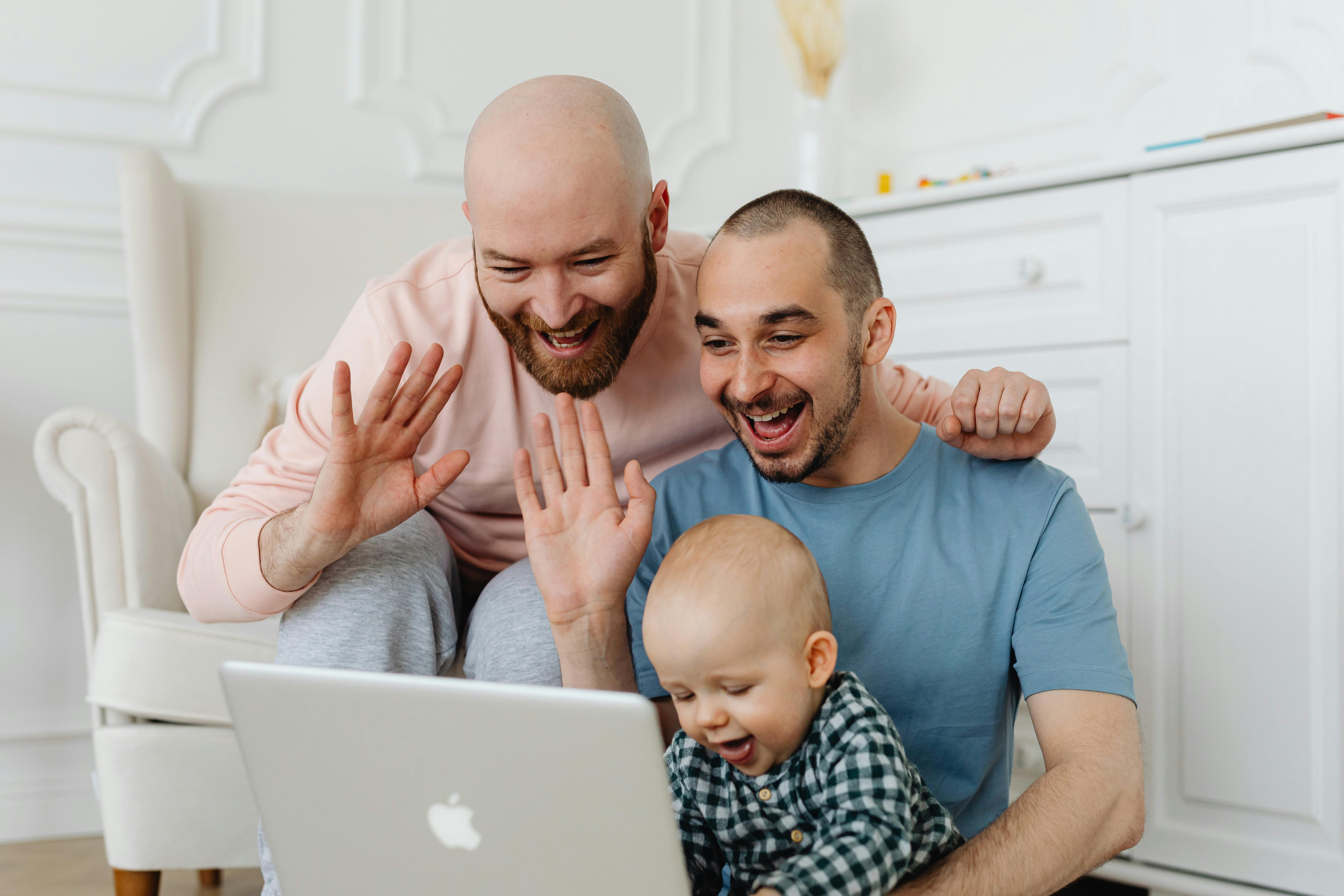 a family making a video call using a laptop