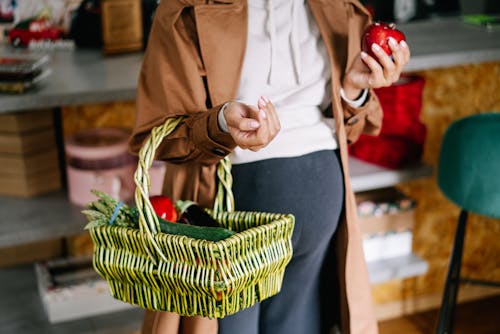 Pregnant Woman Holding Basket with Vegetables 