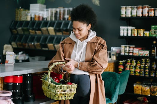 A pregnant woman shops for fresh vegetables at an organic grocery store.