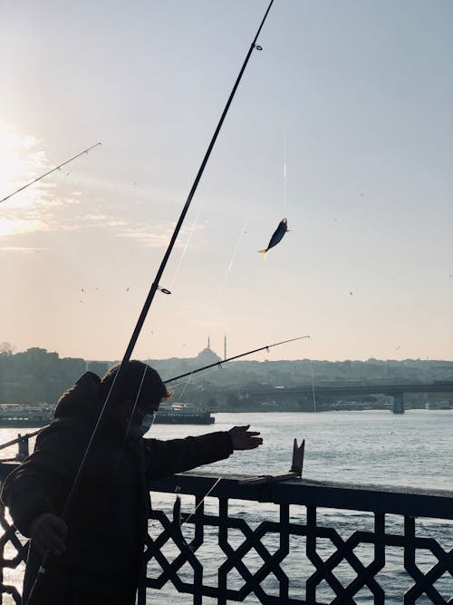 Man Fishing on the Bridge