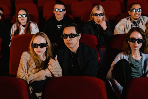 Free People Wearing 3D Glasses while Watching a Movie Stock Photo