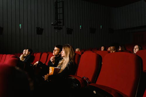 A Couple Eating Popcorn while Watching a Movie