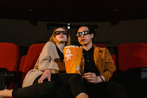 Sweet Couple Watching Movie Together while Eating Popcorn